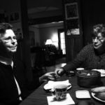 2 older women sits at the kitchen table