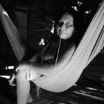 Woman with adorner face in a hammock