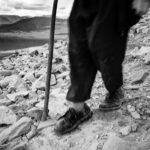 legs and walking stick of Croagh Patrick pilgrim who descents the mountain with a walking stick
