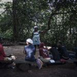 A group of Africans pray in the jungle