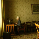 Member of Sisters of Mercy convent sitting at the desk in a room