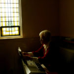 Member of Sisters of Mercy convent sitting at the keyboard