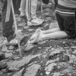 Kneeling, barefoot man at the Croagh Patrick pilgrimage