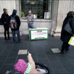 Girl points with her finger at the Islam information stand at Dublin city center