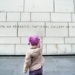 Girl points with her finger at the National Gallery of Ireland building
