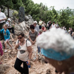People walk the rocky path at Medjugorje pilgrimage site