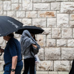 People walk on a rainy day in Medjugorje pilgrimage site