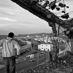 Would-be immigrant watches the port area to find out how the security system works, Tangier, Morocco