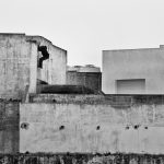 Would-be immigrant enters rooftop to get to the abandoned buildings near the port area. Tangier, Morocco
