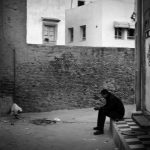 Man sits in front of the house, Kairouan