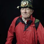 Croagh Patrick male pilgrim with a hat with feathers portrait with black background