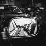 Row of cars seen in the car's side mirror