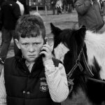 Portrait of a boy talking on the mobile phone at Smithfield horse fair, Dublin