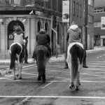 3 bareback riders on the street of Dublin waiting for a green light
