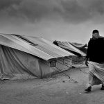 Woman walks among the tents in Choucha camp, Tunisia