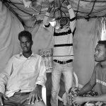 3 African refugees inside the tent, Choucha camp