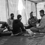 6 men - refugees inside the tent, Choucha refugee camp, Tunisia