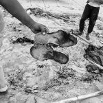 Refugee holds burned shoes, Choucha refugee camp,Tunisia